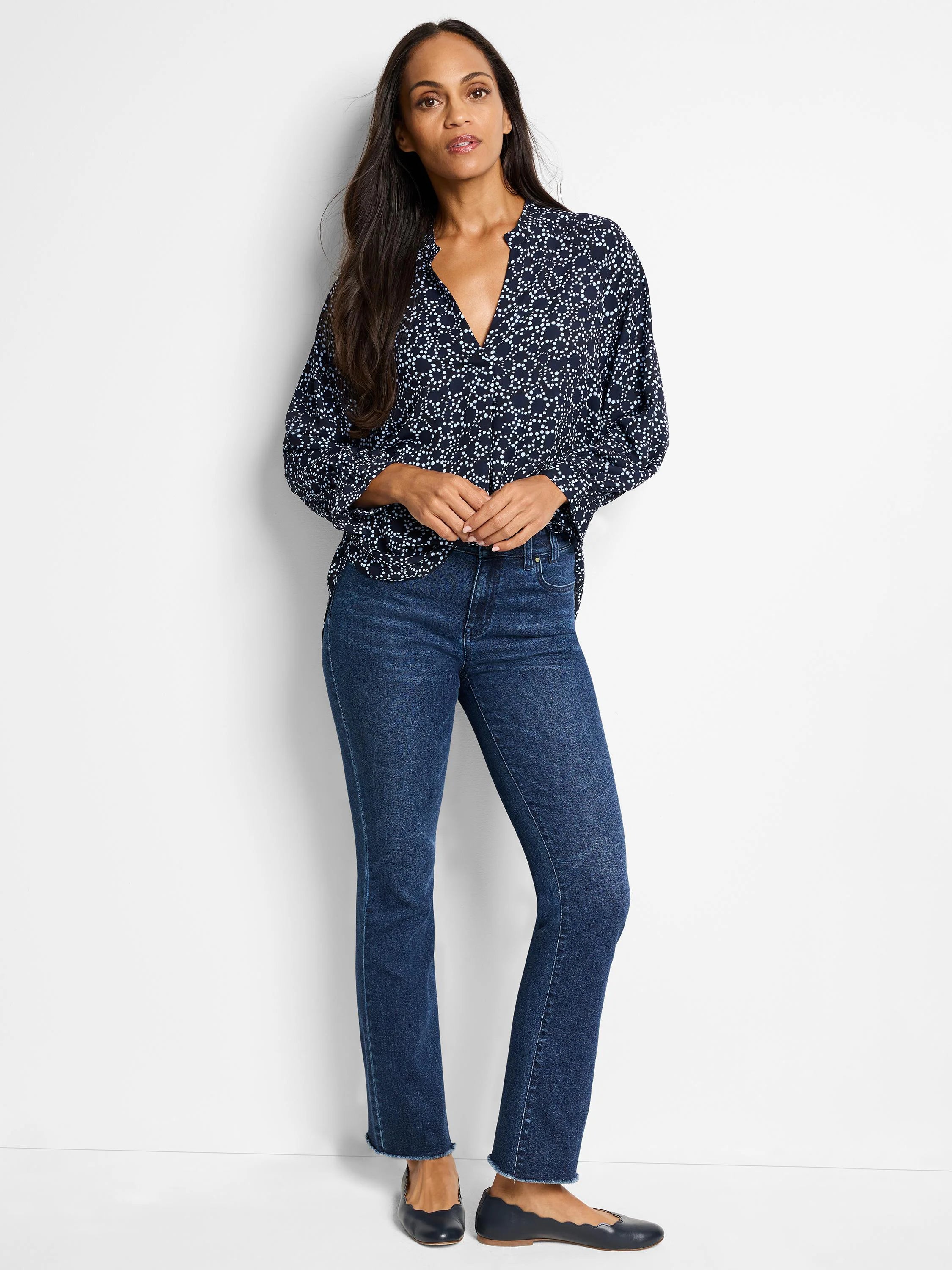 Navy top with light-blue small-scale pattern, worn with dark-wash jeans.