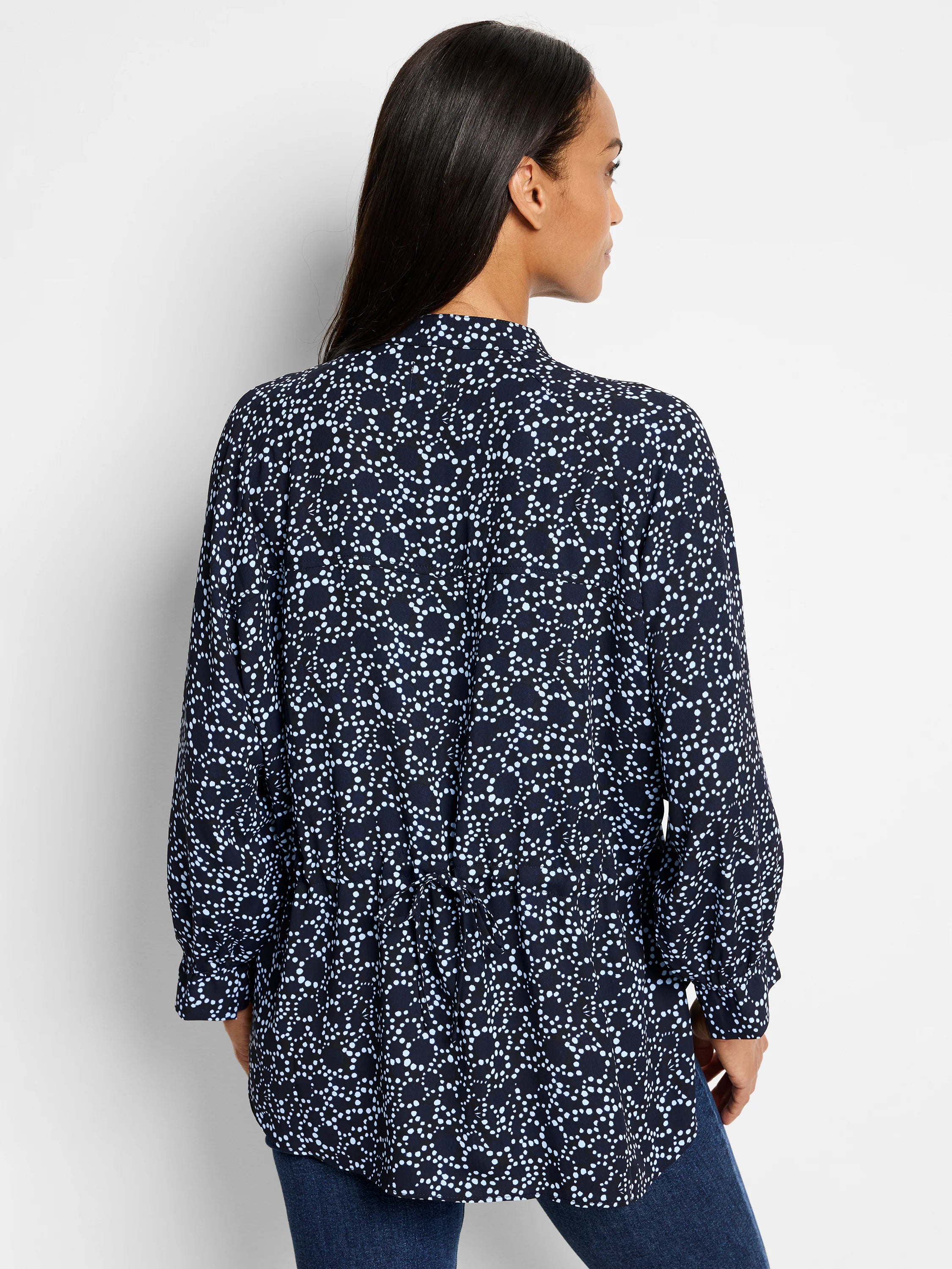 Dark navy top with a light blue polka dot pattern.  Long sleeves, high neck.