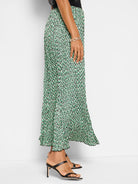 Pleated midi skirt; green, black, & cream abstract dot print.