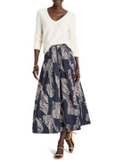 Midi-length pleated skirt in navy blue with off-white zebra-stripe pattern.