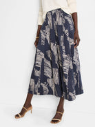 Midi pleated skirt in navy blue with an off-white zebra stripe pattern.