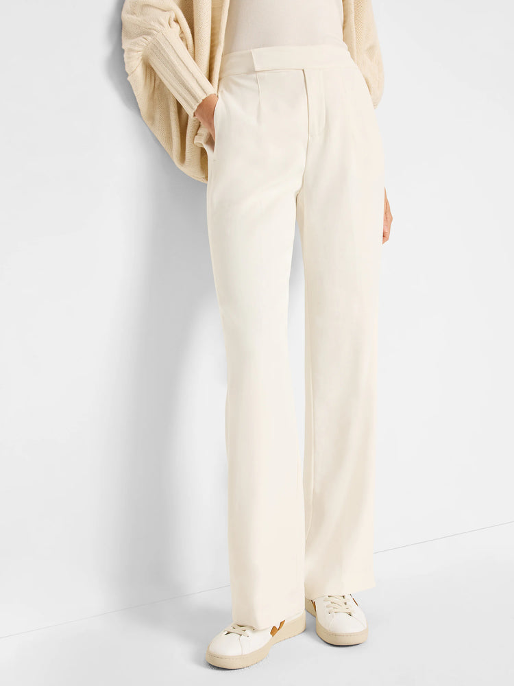 Off-white wide-leg trousers.  High-waisted, with a flat front.  Model is wearing off-white sneakers.
