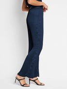 Navy blue, wide-leg pants with vertical pleats.  Shown on a model.