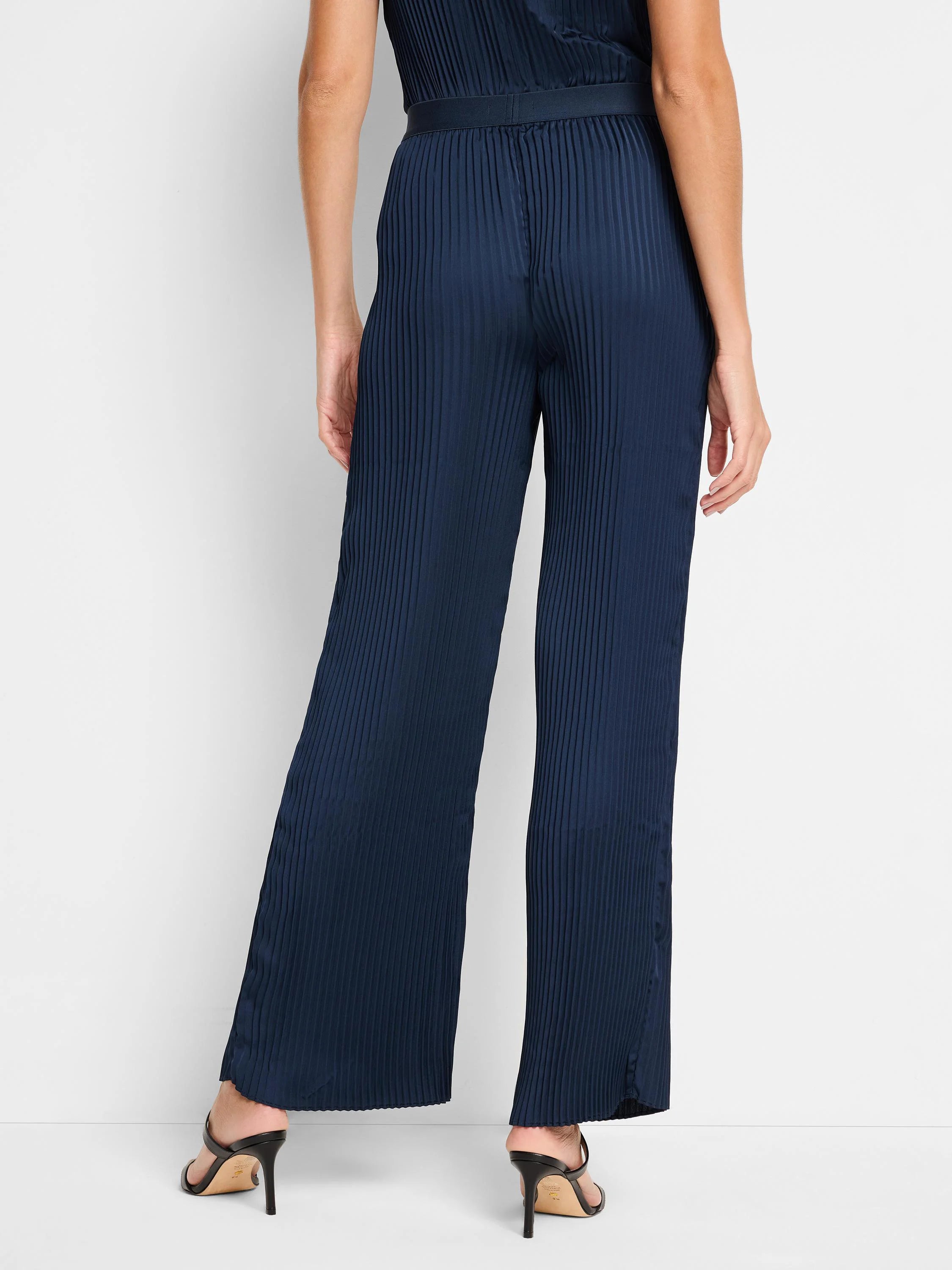 Navy blue, wide-leg pants with vertical pleats.  Back view;  shows a fitted waist.