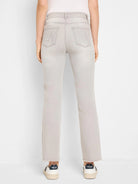 Light grey, faded demi boot jeans, back view, with decorative back pocket stitching and frayed hems.