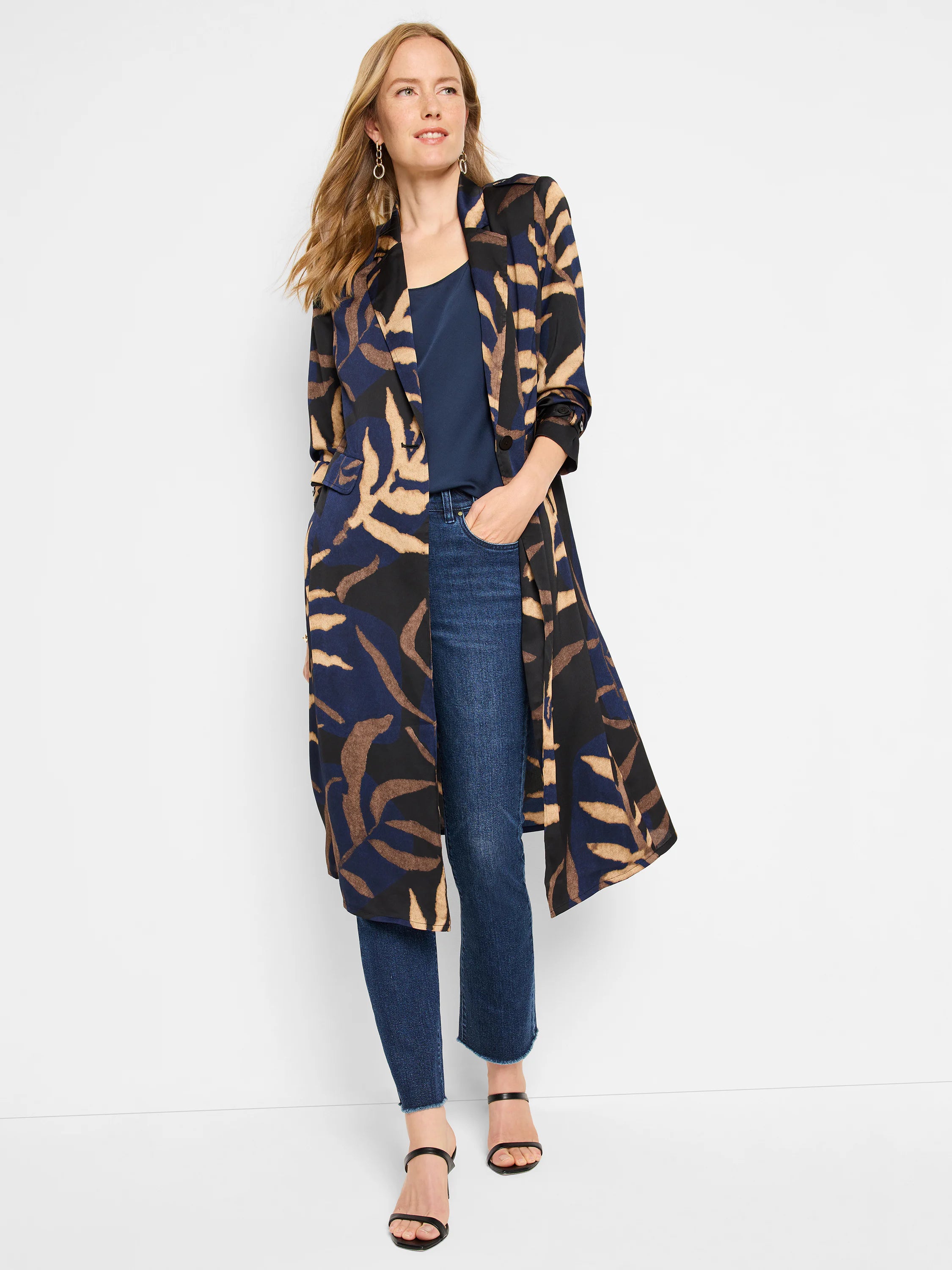 Dark blue mid-rise demi boot jeans with a subtle leg flare and distressed, frayed ankle hems.