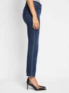 Dark wash denim jeans, straight leg, cropped at ankle.  Small embroidered detail on back pocket.  Model wears black heels.