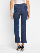 Dark wash denim bootcut jeans; back view shows two back pockets with subtle stitching detail.