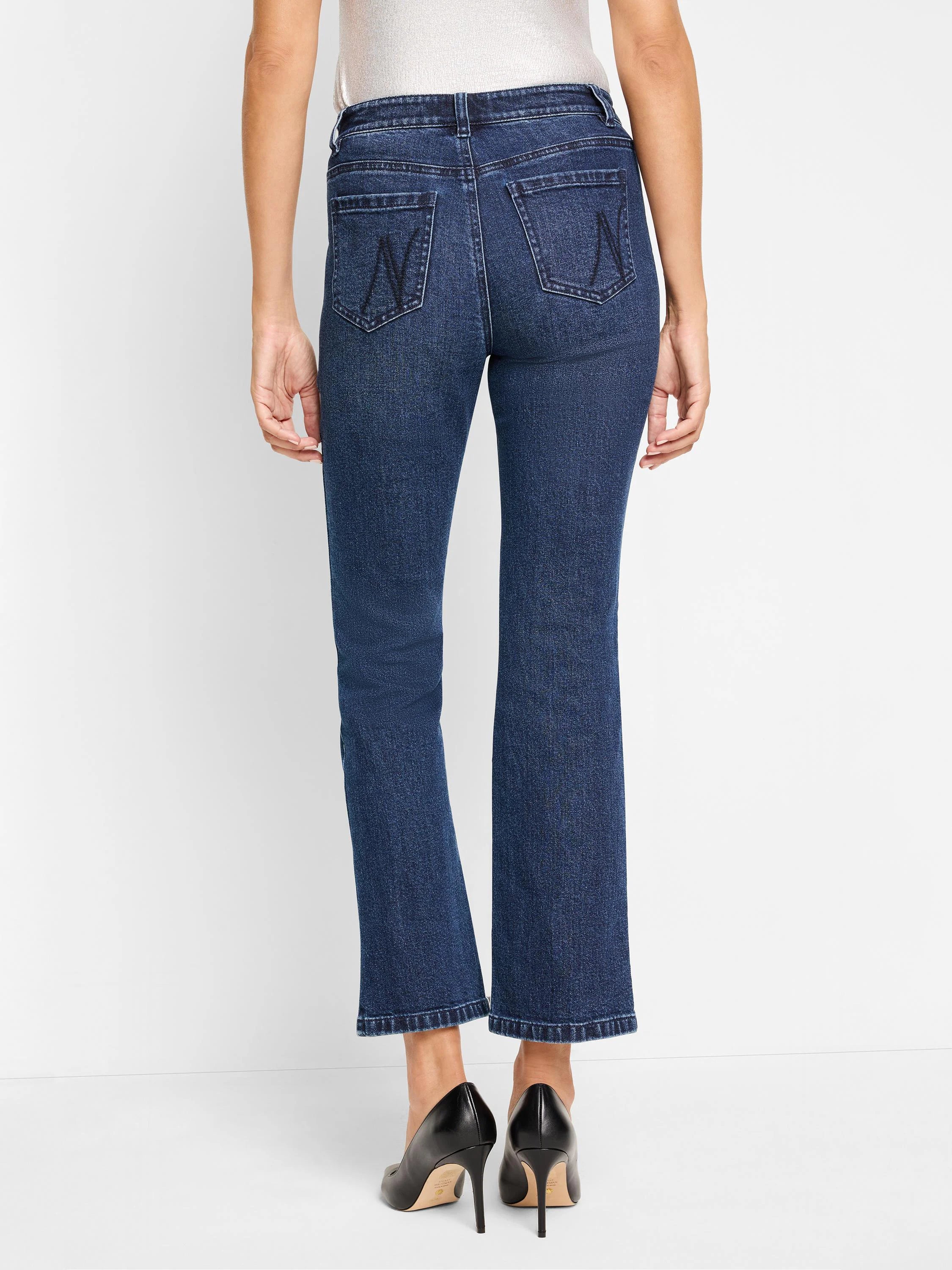 Dark wash denim bootcut jeans; back view shows two back pockets with subtle stitching detail.