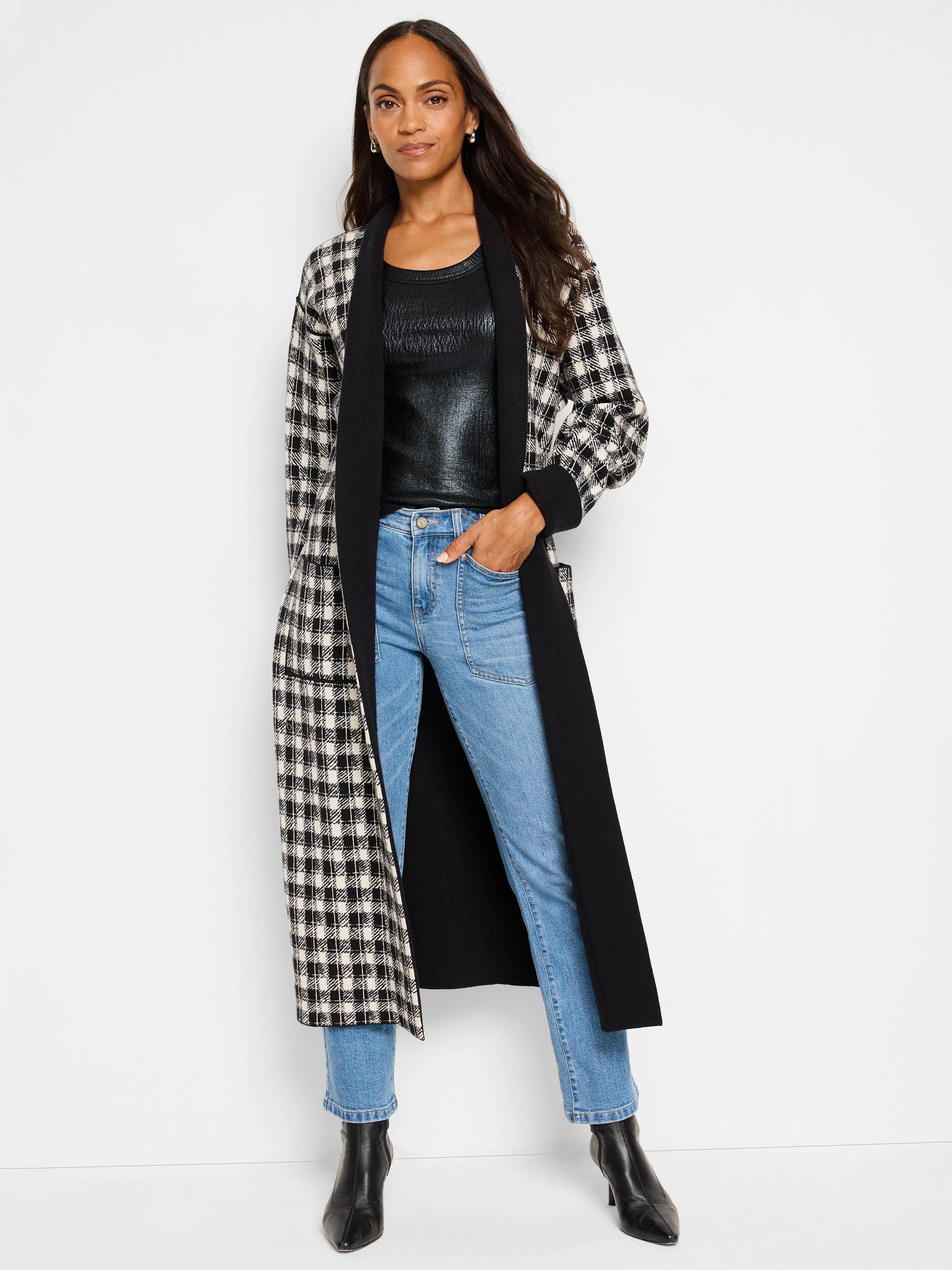 Mid-rise, straight-leg jeans in light blue denim.  Shown with black and cream gingham-patterned coat.