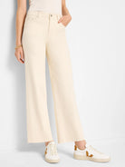 Ecru wide-leg jeans with front pockets, a button, and frayed ankle hems.