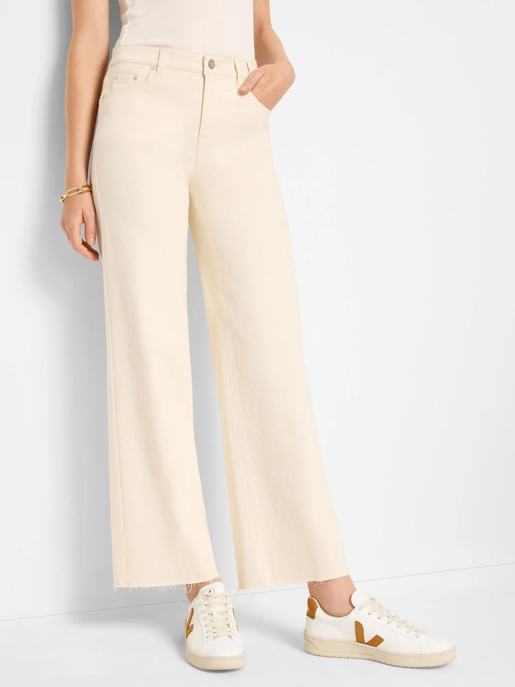 Ecru wide-leg jeans with front pockets, a button, and frayed ankle hems.