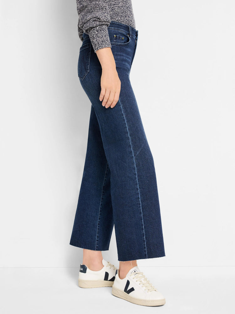 Dark blue wide leg jeans, cropped at ankle, with light fading on seams and a raw hem.