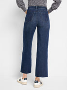 Dark blue denim wide leg jeans, cropped with a raw hem. Back patch pockets feature a distinct stitched design.