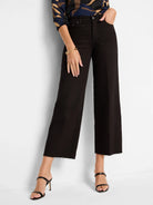 Black wide-leg jeans, cropped with a raw, frayed hem.