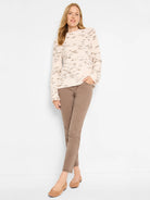 Taupe straight ankle jeans shown on a model. They feature a uniform color and end above the ankle.