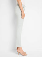 Pale blue, slim straight ankle jeans on a model, showing a cropped hem.