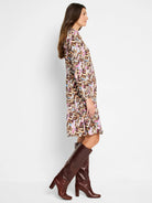 Brown midi dress with pink, blue, and beige abstract print.  Long sleeves, collared neckline.