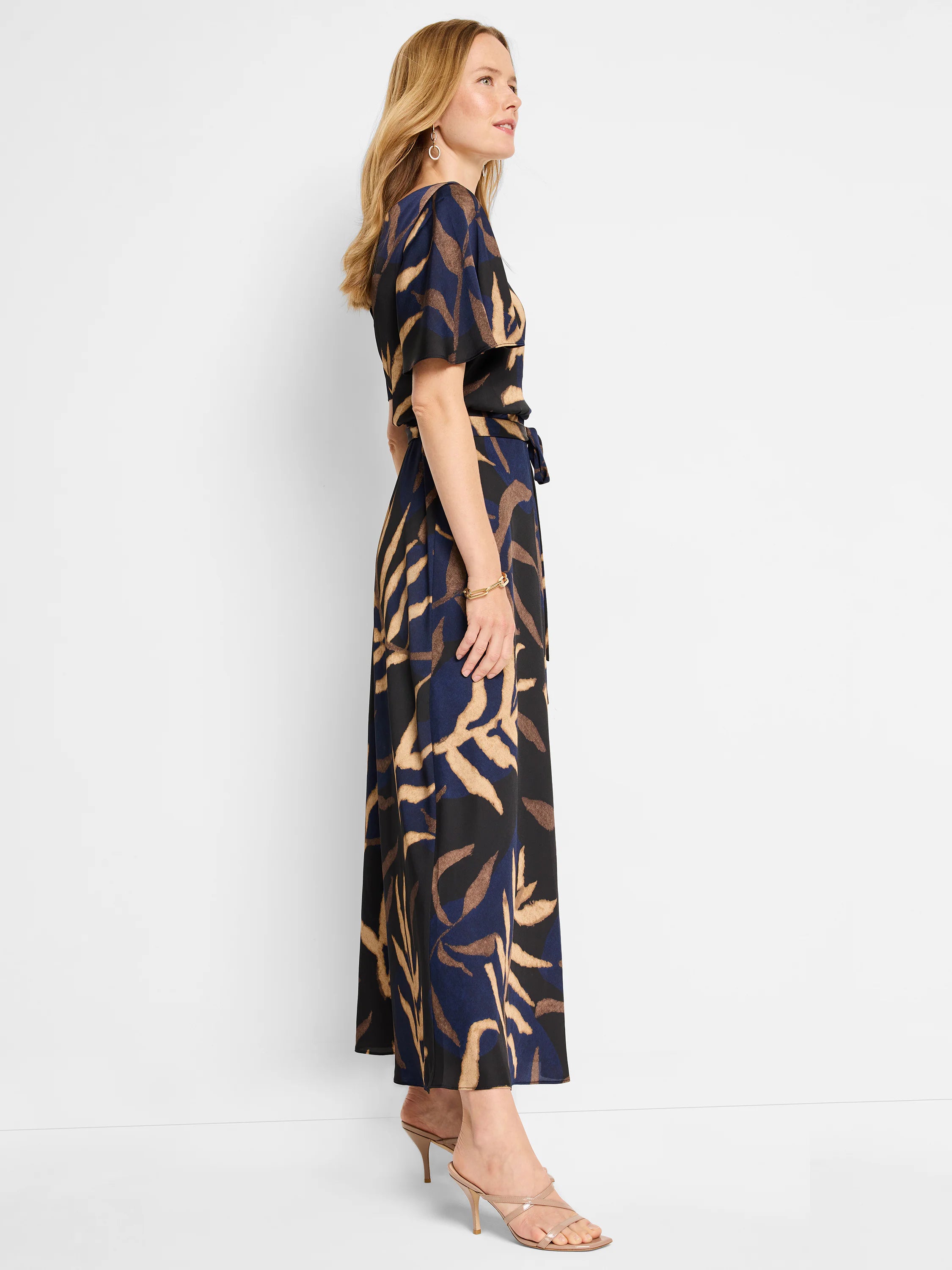 Midnight blue maxi dress with beige and brown leaf print.  Short flutter sleeves, belted waist.