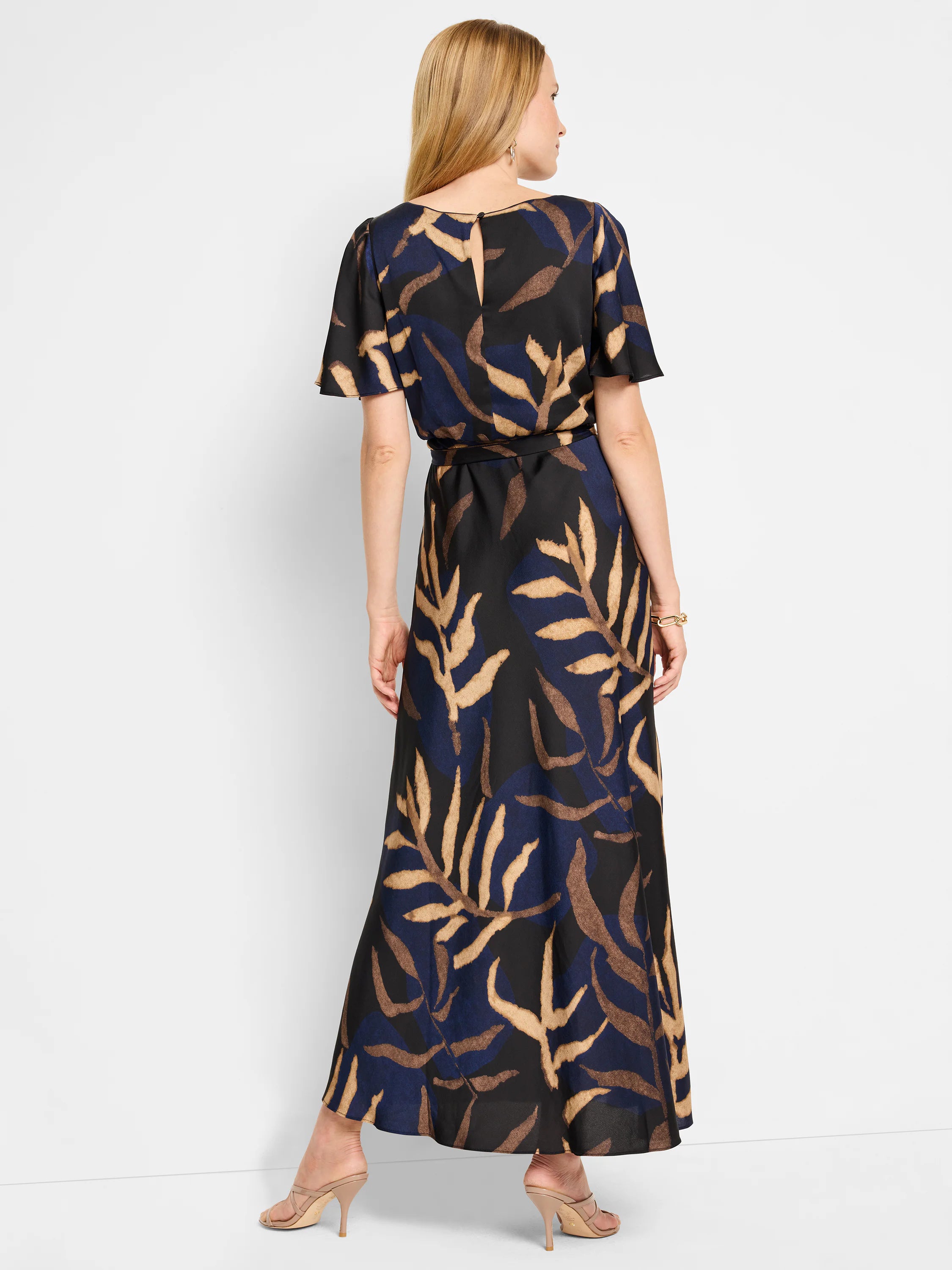 Black maxi dress with navy and tan leaf print. Flutter sleeves, keyhole back.  A-line skirt.