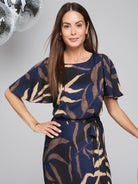 Midnight blue dress with beige and black leaf print.  Short flutter sleeves, belted waist.