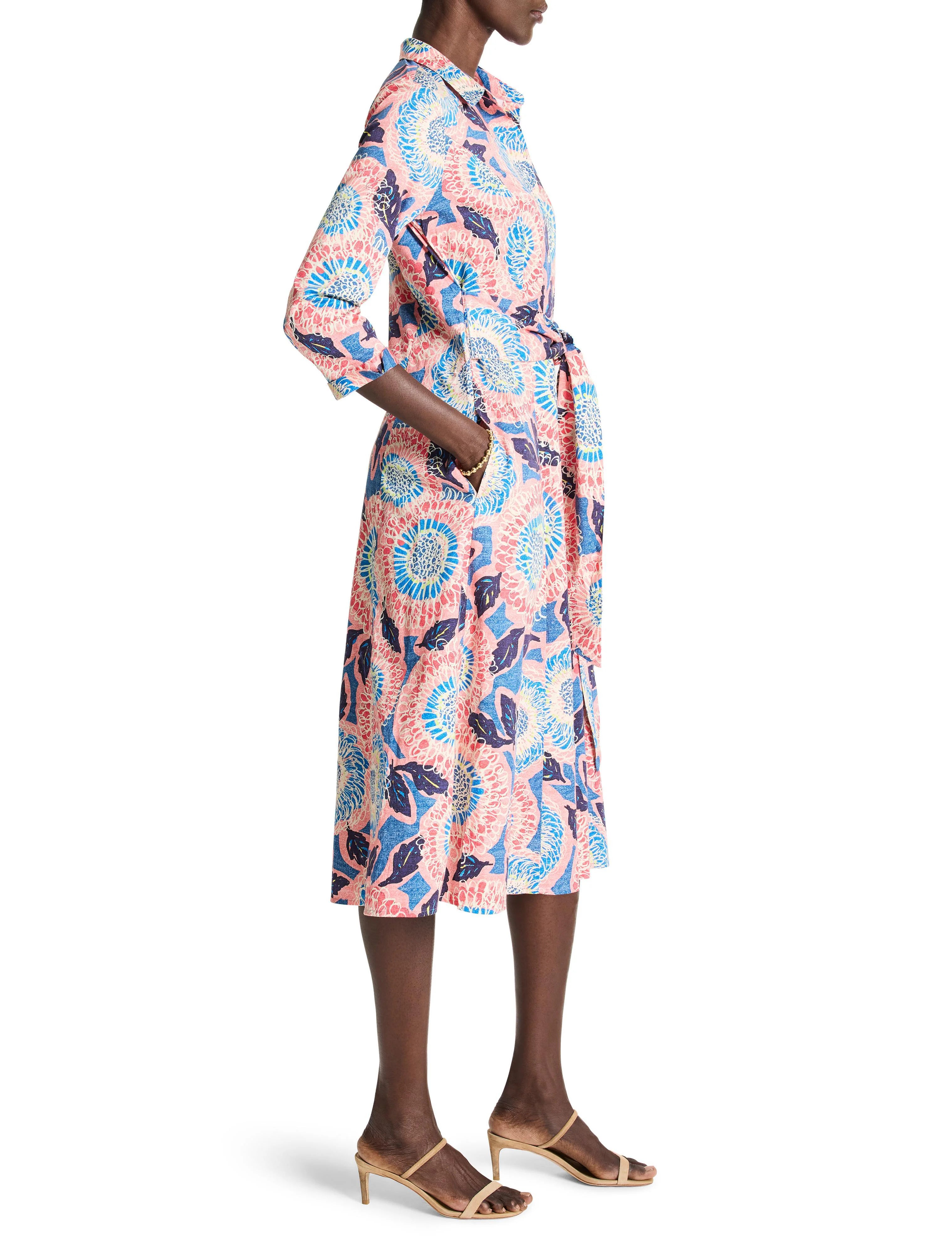 Pink, blue, and white floral shirt dress with a belted waist and midi length.  Three-quarter sleeves.