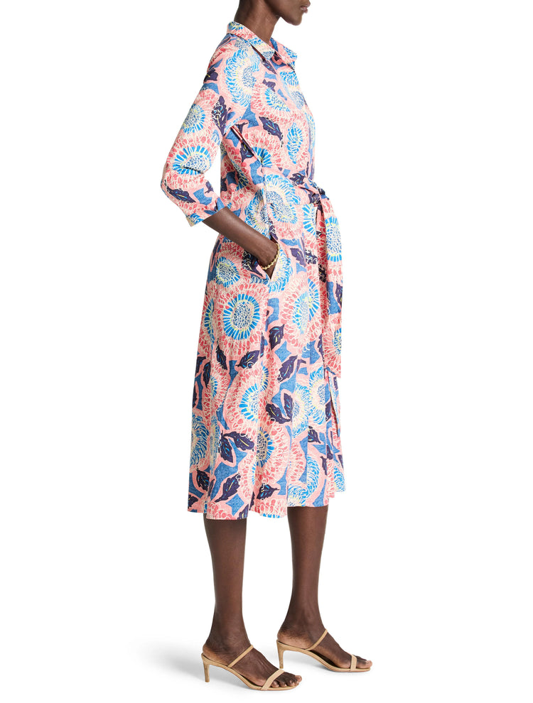 Pink, blue, and white floral shirt dress with a belted waist and midi length.  Three-quarter sleeves.