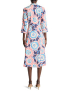 Pink midi shirt dress with blue, white, and dark purple floral print. Three-quarter sleeves.