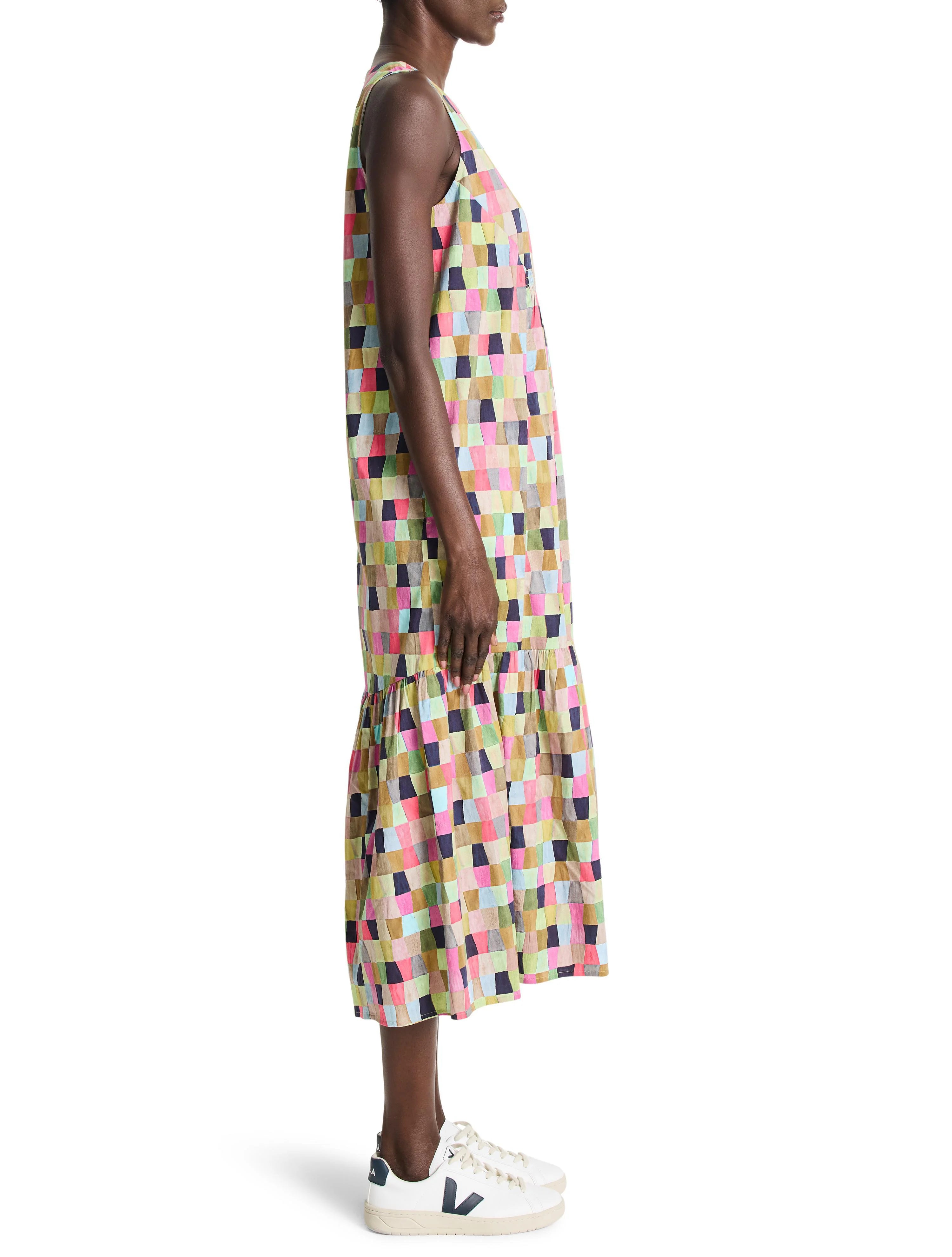 Sleeveless midi dress with multicolored patchwork print in pinks, greens, blues, and neutrals.  A-line silhouette with a...