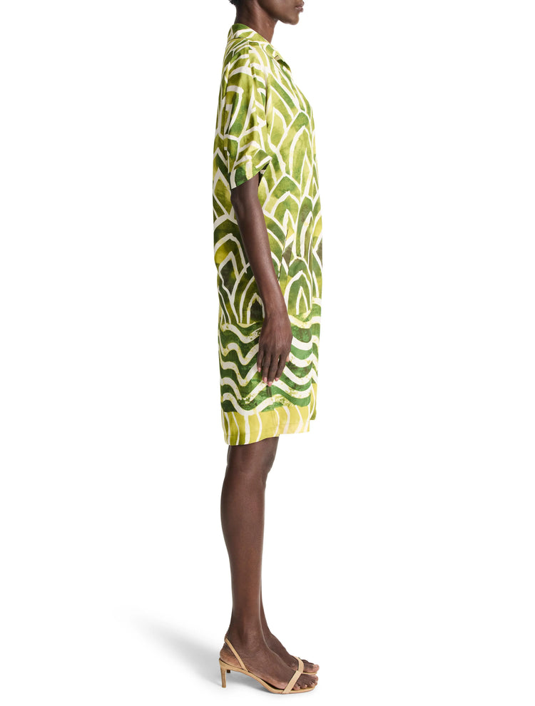 Green and cream short-sleeved collared shirt dress with an abstract leaf-like pattern. Side view.