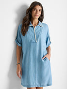 Light blue denim dress, short sleeves, collared neckline with off-white trim, and pockets.