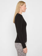 Black, long-sleeved, fitted V-neck top with a ribbed knit texture, shown on a model.