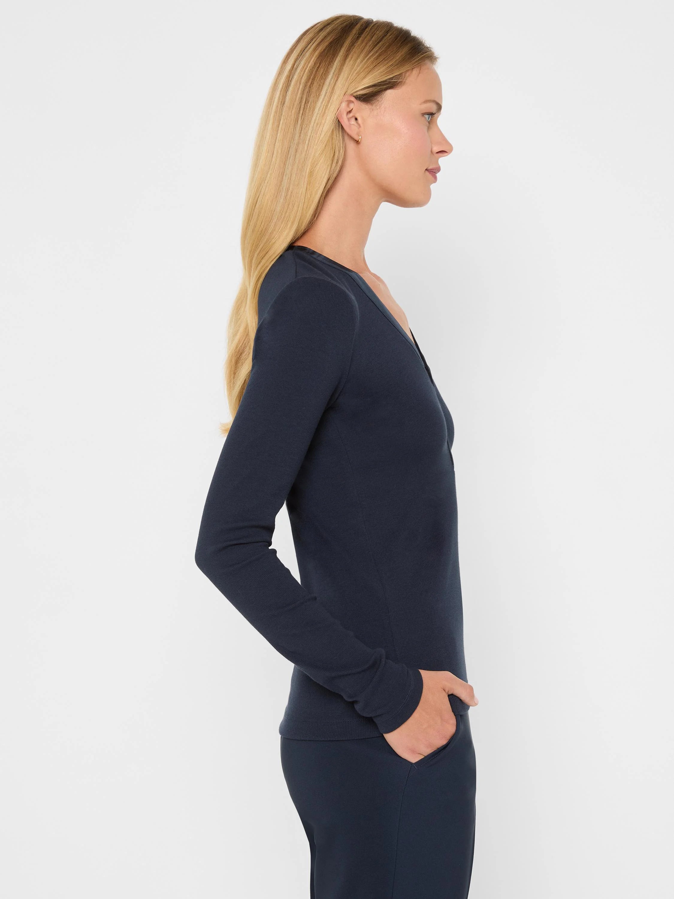 Dark navy blue ribbed knit V-neck long-sleeve top.