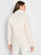 Cream curly boucle jacket, mock neck, long sleeves, shown from the back on a model.