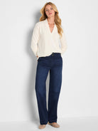 Cream cable knit V-neck top with long sleeves.