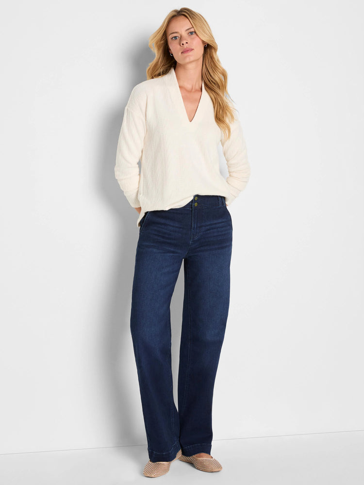 Cream cable knit V-neck top with long sleeves.