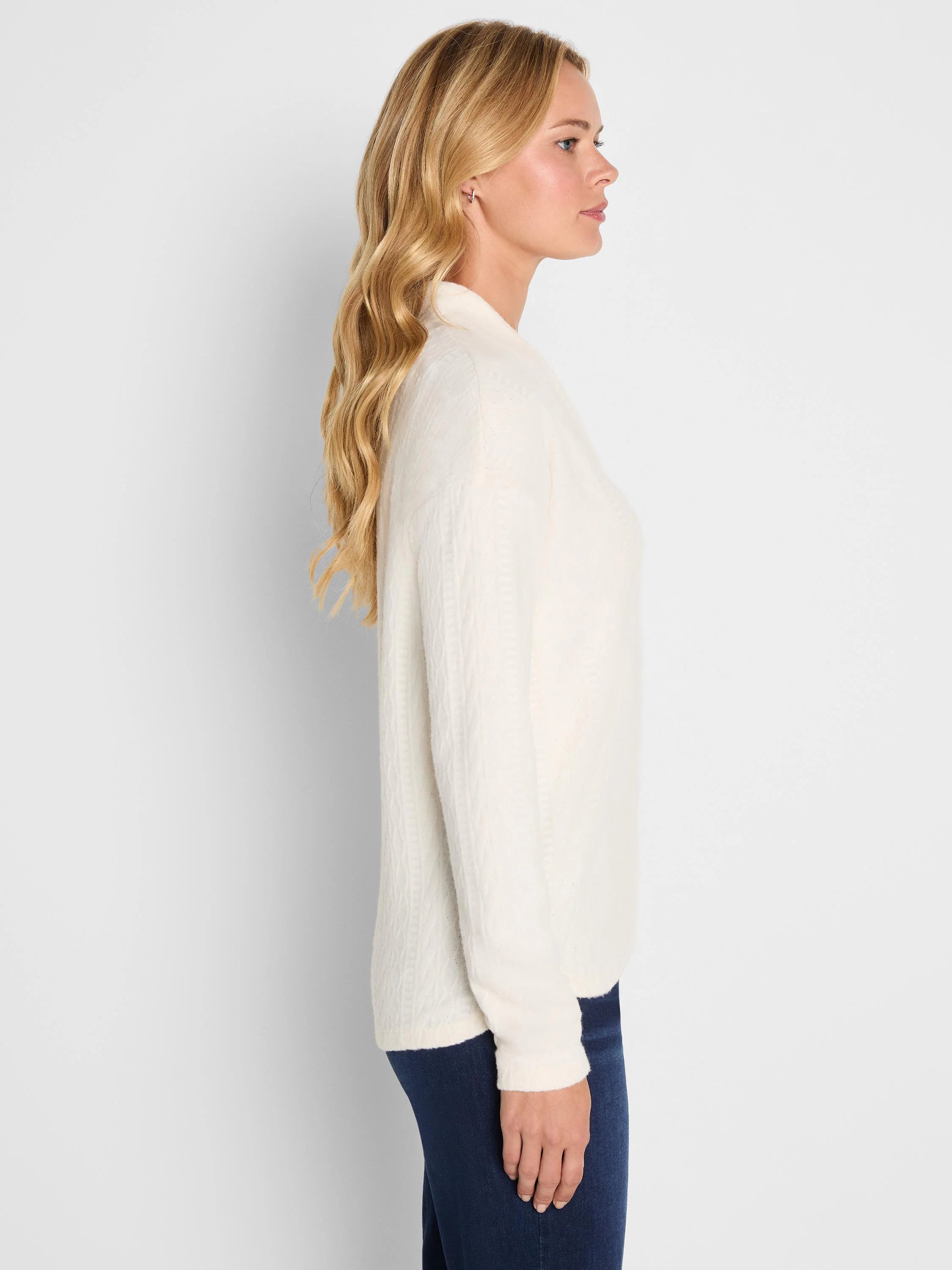 Cream cable knit long-sleeve top on model.