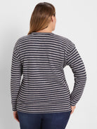 Back view of a waffle-knit long-sleeve top with alternating dark blue and light gray horizontal stripes.