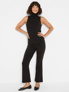 Black ribbed knit sleeveless turtleneck tank.