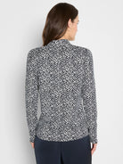 Black & white long-sleeved collared knit top with a dense, abstract brushstroke pattern.