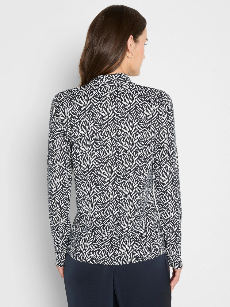 Black & white long-sleeved collared knit top with a dense, abstract brushstroke pattern.