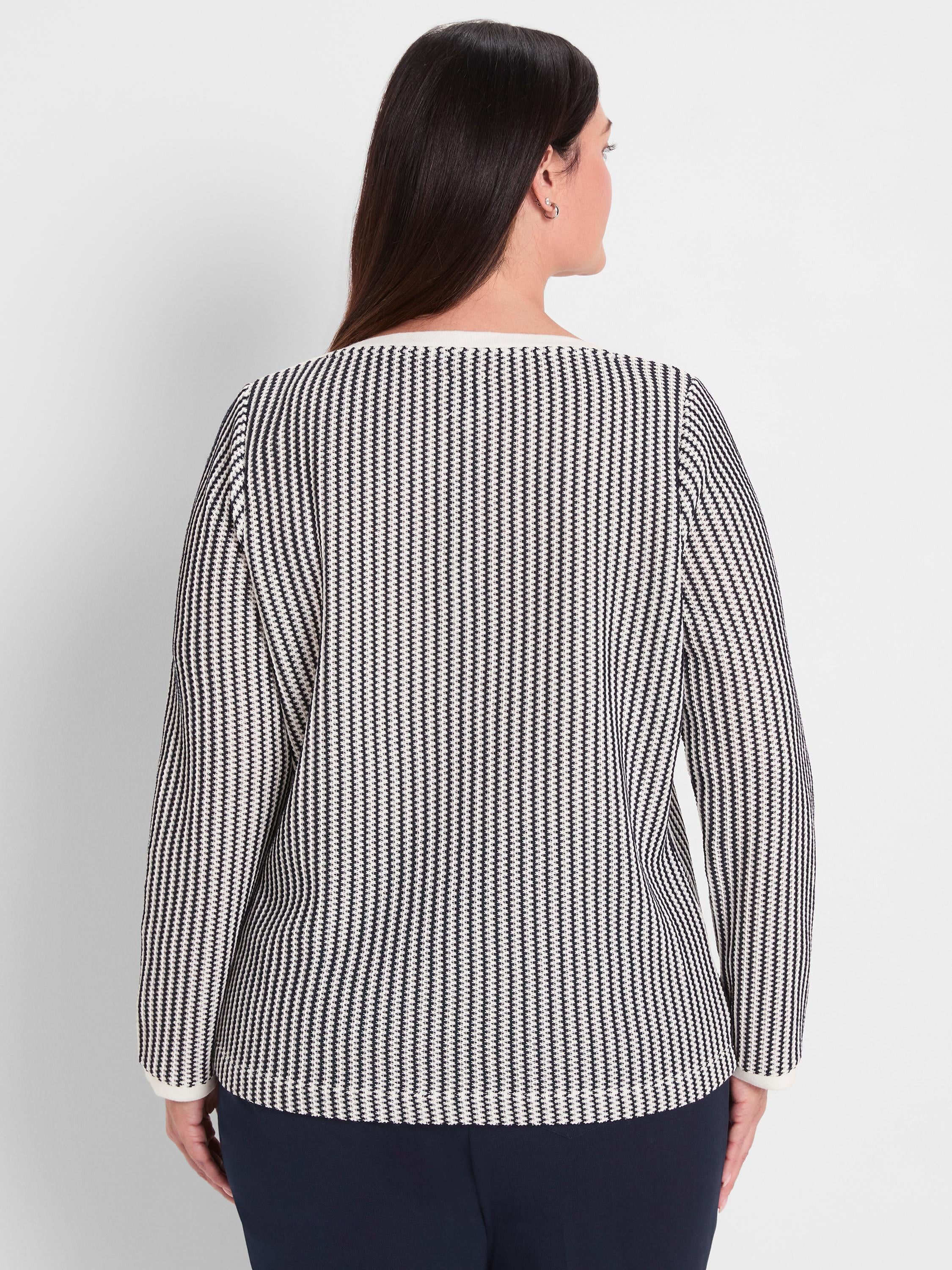 Black and white patterned knit top with long sleeves features a standard fit and contrasting white trim detail.