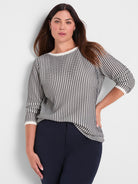 A relaxed fit black and white geometric knit sweater with three-quarter sleeves and a contrast crew neck.