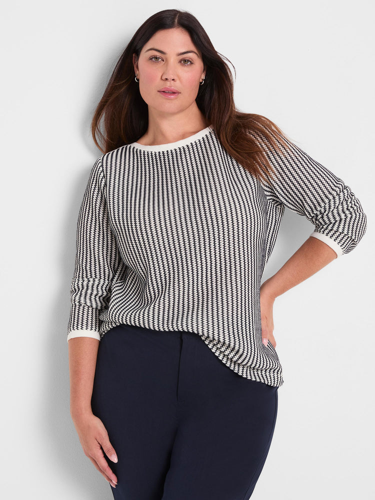 A relaxed fit black and white geometric knit sweater with three-quarter sleeves and a contrast crew neck.