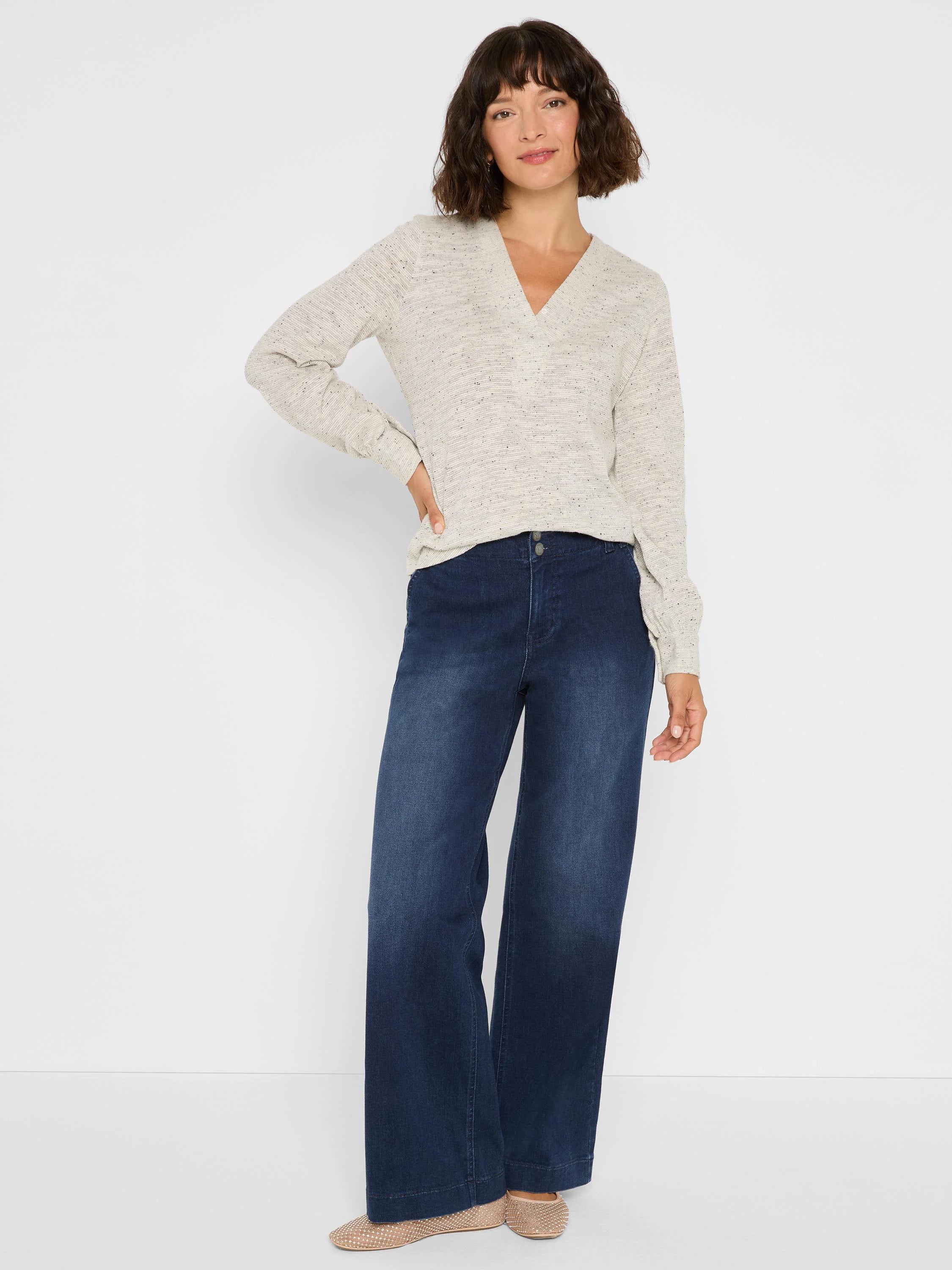 Light beige V-neck knit top with dark speckled nep texture and long sleeves.