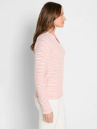 Off-white thermal top with thin pink horizontal stripes. Long sleeves, split neck.