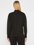 Black long-sleeve mock neck top with fine horizontal sparkle stripes. Back view.