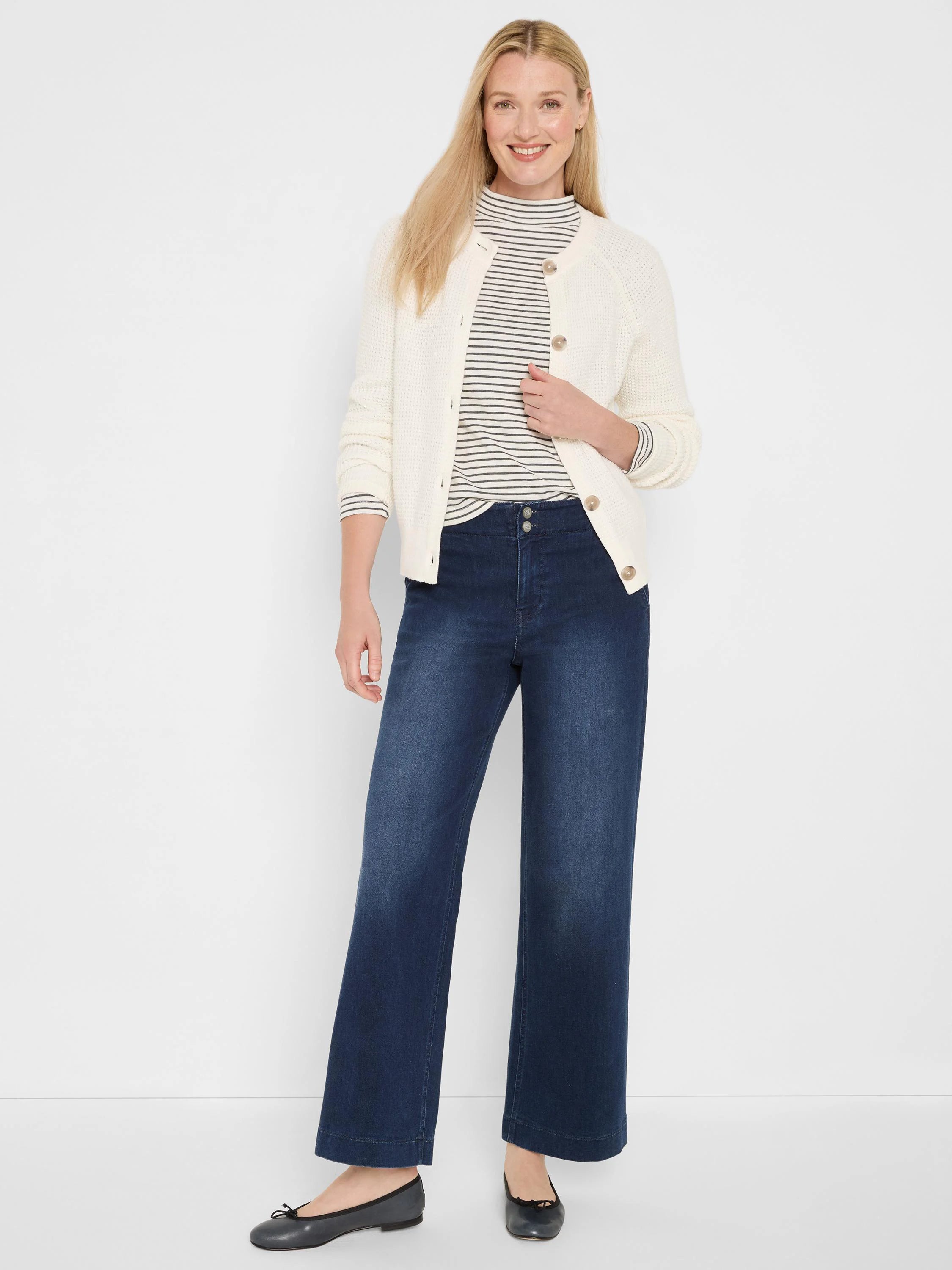 Off-white cardigan with visible waffle texture and tan button-front closure.