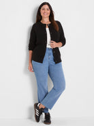 Black waffle knit cardigan with a crew neck, 3/4 sleeves, and dark front buttons.