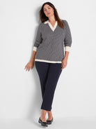 Two-tone navy and cream chevron jacquard sweater with a polo collar, 3/4 sleeves, and ribbed trim.